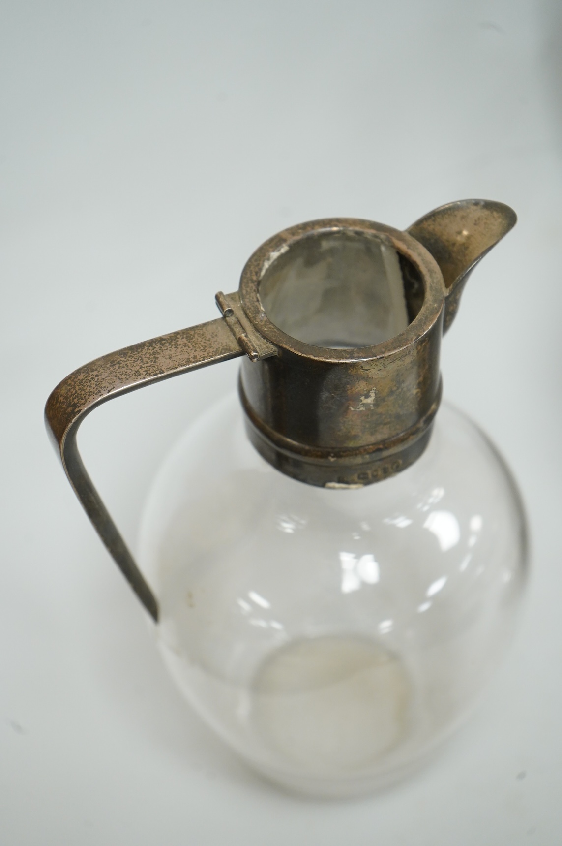 A late Victorian silver mounted claret jug (lacking cover), Holland, Son & Slater, London, 1882, height 21.1cm, together with a sterling sauce ladle, a plated two handled oval pedestal soup tureen and a cased set of six